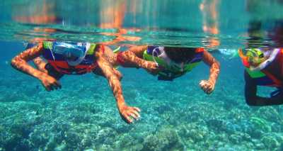 Three friends snorkeling in indonesian coastal waters